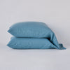 Linen Standard Pillowcase (Single) | Cenote | Two sleeping pillows neatly stacked against a white background - side view.