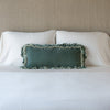 Loulah Throw Pillow | Eucalyptus | pillow on a white bed - cropped end of bed view.