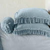 Loulah Sham | Cloud | Two shams stacked flat next to matching bolster. Close-up side view highlights the ruffle trim.