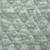 Luna Sham | Eucalyptus | A close up of quilted charmeuse fabric in eucalyptus, a soft light green.