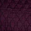 Luna Coverlet | Fig | A close up of quilted charmeuse fabric in fig, a richly saturated purple-garnet.