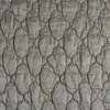 Luna Coverlet | Fog | A close up of quilted charmeuse fabric in fog, a neutral-warm, soft mid-tone grey.