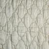 Luna Twin Coverlet | Parchment | A close up of quilted charmeuse fabric in parchment, a warm, antiqued cream.
