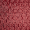 Luna Twin Coverlet | Poppy | A close up of quilted charmeuse fabric in poppy, a warm coral pink.