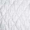 Luna Sham | White | A close up of quilted charmeuse fabric in classic white.