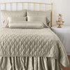 Luna Sham | Fog | shams on a shining, monochromatic bed with matching coverlet - end of bed view.