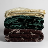 Stack of three lynette blankets shows filled and unfilled blanket styles. The top blanket is in parchment, is throw blanket sized and unfilled. The middle and bottom blankets are bed end sized and shown in Jade and Moonlight - all against a white background.