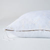Lynette Throw Pillow | White | Close-up side vew featuring brass zipper with charmeuse pull and linen back.