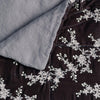 Lynette Blanket | Moonlight | Close up of blanket, with a corner turned back to showcase the linen back - overhead view.
