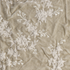 Lynette Sham | Parchment | A close up of embroidered silk velvet fabric in parchment, a warm, antiqued cream.