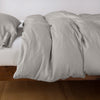 Madera Luxe Twin Duvet Cover | Fog | duvet cover with matching sleeping pillow and fitted sheet - side view.