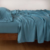 Madera Luxe Fitted Sheet | Cenote | fitted sheet with matching rumpled flat sheet and sleeping pillow - side view.