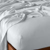 Madera Luxe Fitted Sheet | Cloud | fitted sheet with matching rumpled flat sheet - top corner view.