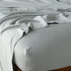 Madera Luxe Fitted Sheet | Eucalyptus | fitted sheet with matching rumpled flat sheet - top corner view.