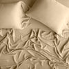 Madera Luxe Fitted Sheet | Honeycomb | rumpled sheeting and sleeping pillows - overhead view.