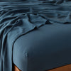 Madera Luxe Fitted Sheet | Midnight | fitted sheet with matching rumpled flat sheet - top corner view.