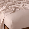 Madera Luxe Fitted Sheet | Rouge | fitted sheet with matching rumpled flat sheet - top corner view.