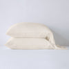Madera Luxe Pillowcase (Single) | Parchment | sleeping pillows stacked neatly against a white backdrop - side view.