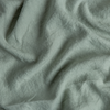 Midweight Linen Swatch | Eucalyptus | A close up of midweight linen fabric in eucalyptus, a soft light green.