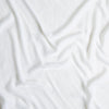 Carmen Baby Blanket | White | A close up of silk velvet fabric in classic white.
