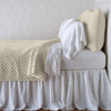 Silk Velvet Quilted Coverlet | Parchment | coverlet with matching shams and white sheeting - side view.
