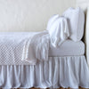 Silk Velvet Quilted Twin Coverlet | White | coverlet with matching shams and white sheeting - side view.