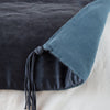 Taline Blanket | Midnight | Close up of blanket, with a corner turned back to showcase the midweight linen back and corner tassel - overhead view.
