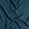 Madera Luxe Flat Sheet | Midnight | A close up of tencel™ fabric in midnight, a rich indigo tone.