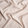 Madera Luxe Flat Sheet | Pearl | A close up of tencel™ fabric in pearl, a nude-like, soft rose pink tone.