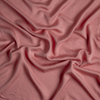 Madera Luxe Twin Flat Sheet | Poppy | A close up of tencel™ fabric in poppy, a warm coral pink.