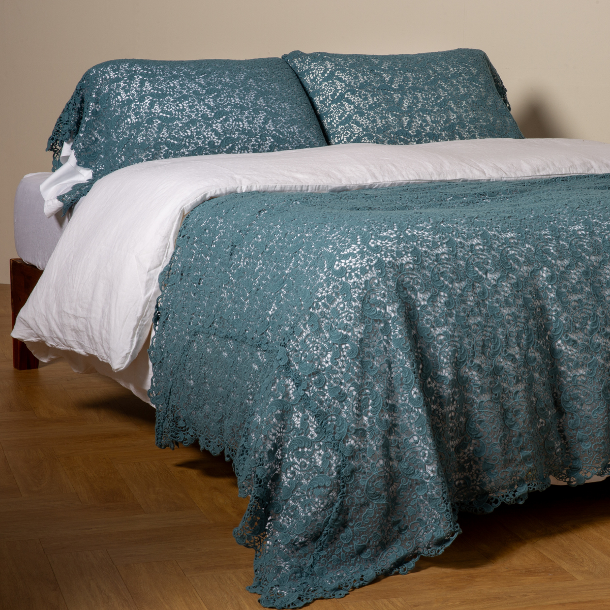 Allora Bed Scarf | Cenote | cotton lace bed scarf draped across the foot of a bed dressed in linen sheets and duvet cover in winter white -  shown with matching lace pillowcase covers over a linen liner in winter white.