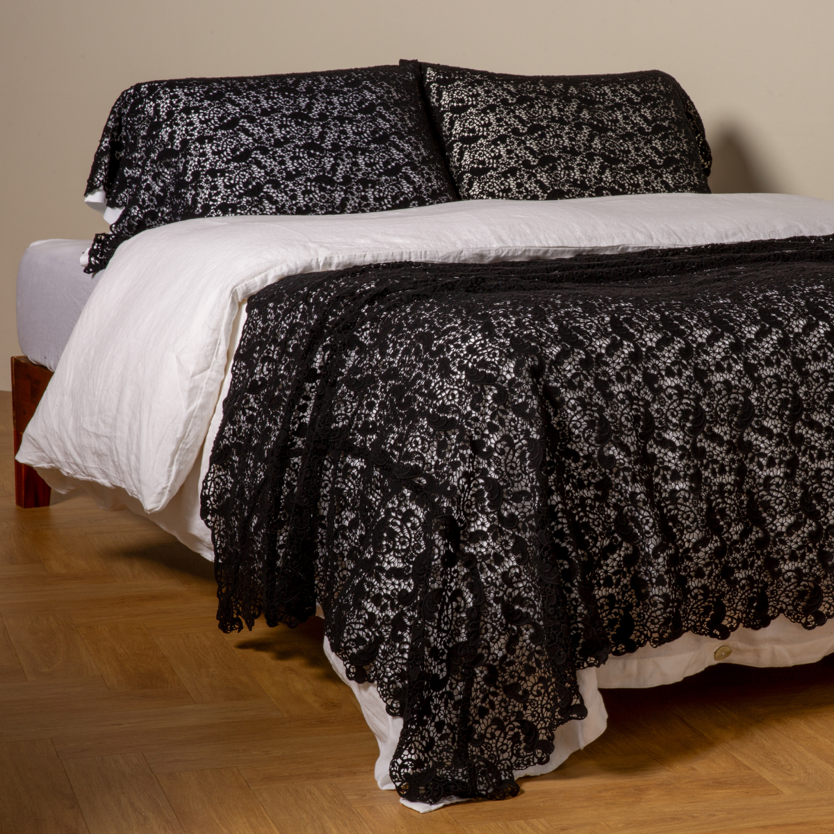 Allora Bed Scarf | Corvino | cotton lace bed scarf draped across the foot of a bed dressed in linen sheets and duvet cover in winter white -  shown with matching lace pillowcase covers over a linen liner in winter white.