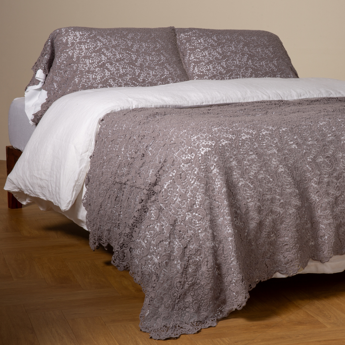 Allora Bed Scarf | French Lavender | cotton lace bed scarf draped across the foot of a bed dressed in linen sheets and duvet cover in winter white -  shown with matching lace pillowcase covers over a linen liner in winter white.