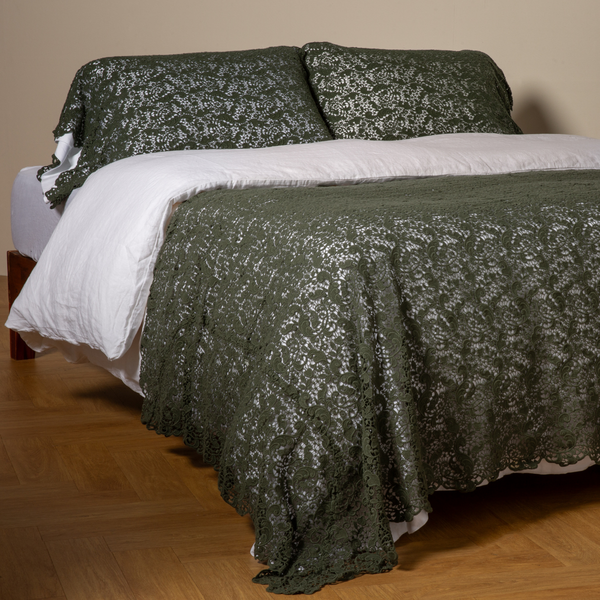 Allora Bed Scarf | Juniper | cotton lace bed scarf draped across the foot of a bed dressed in linen sheets and duvet cover in winter white -  shown with matching lace pillowcase covers over a linen liner in winter white.