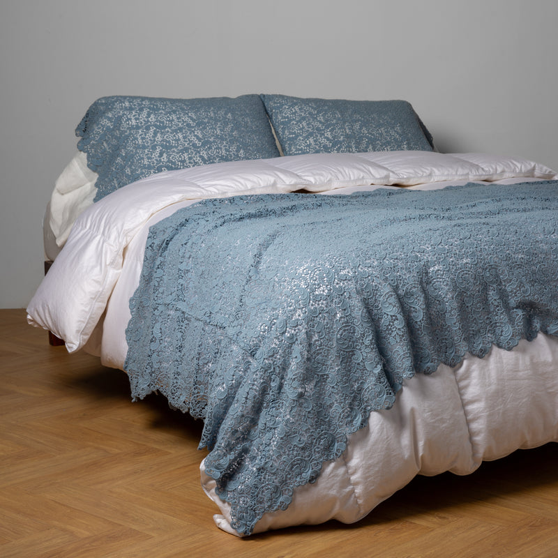 Allora Bed Scarf | Tahoe Blue | cotton lace bed scarf draped across the foot of a bed dressed in linen sheets and duvet cover in winter white -  shown with matching lace pillowcase covers over a linen liner in winter white.