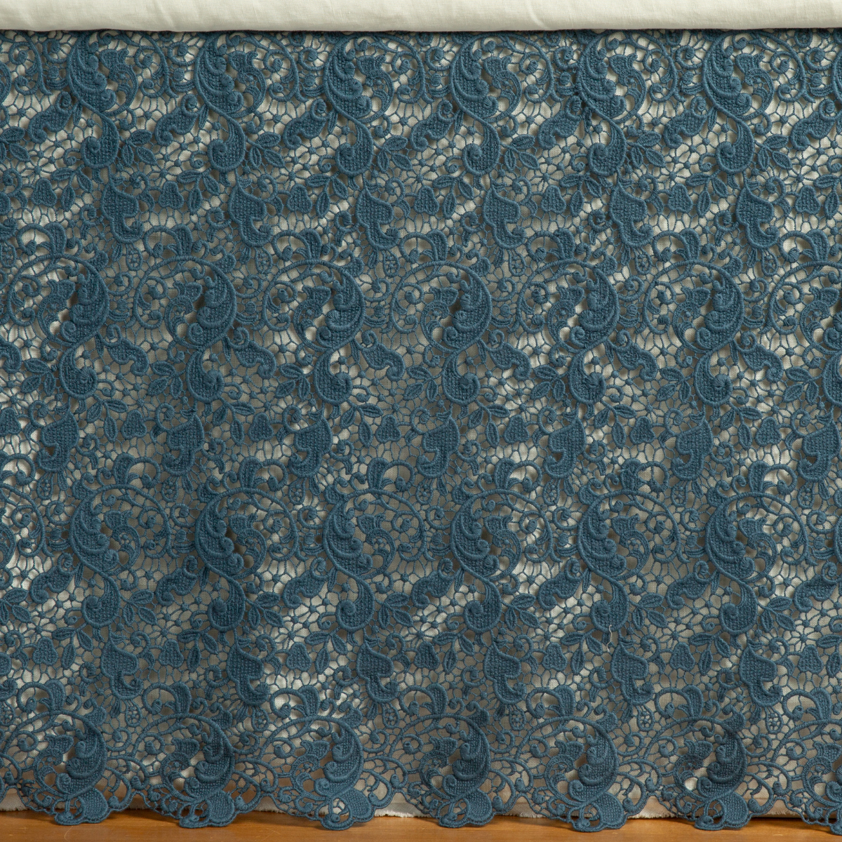 Allora Bed Skirt | Midnight | a close up of a cotton lace bed skirt layered over a winter white bed skirt - shot straight at the bed skirt.