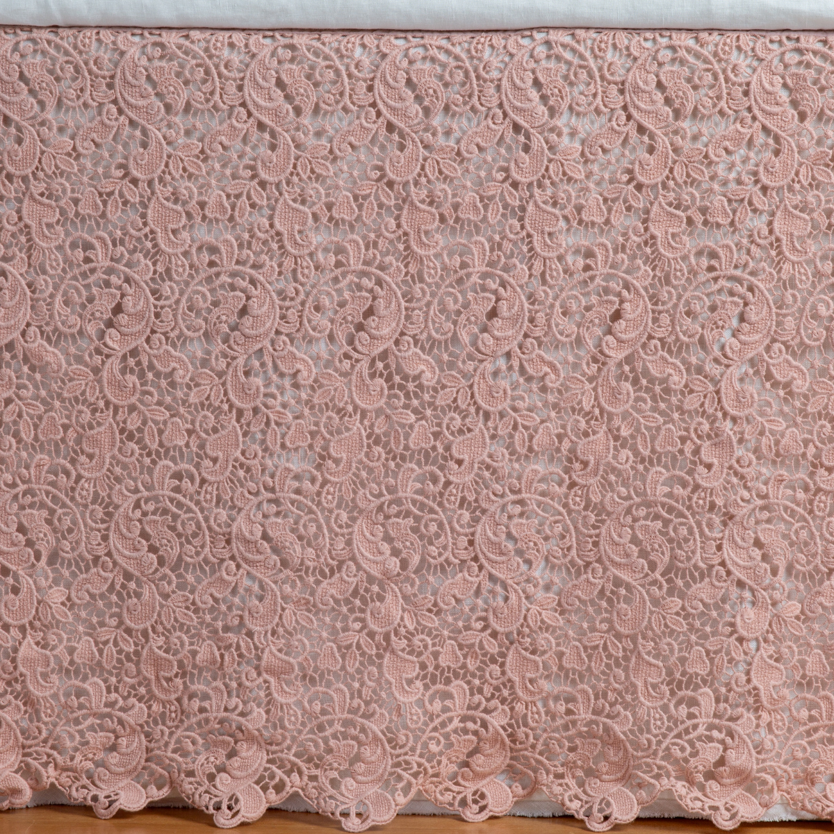 Allora Bed Skirt | Rouge | a close up of a cotton lace bed skirt layered over a winter white bed skirt - shot straight at the bed skirt.