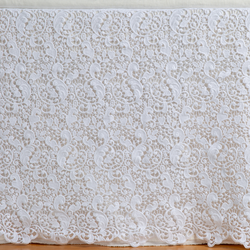 Allora Bed Skirt | White | a close up of a cotton lace bed skirt layered over a winter white bed skirt - shot straight at the bed skirt.