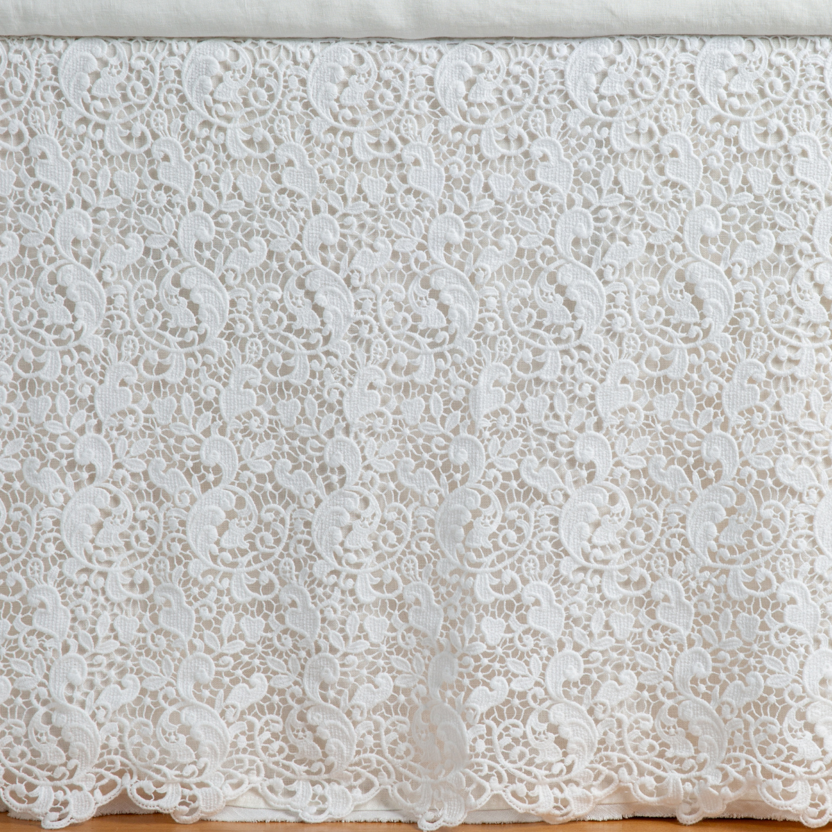 Allora Bed Skirt | Winter White | a close up of a cotton lace bed skirt layered over a winter white bed skirt - shot straight at the bed skirt.