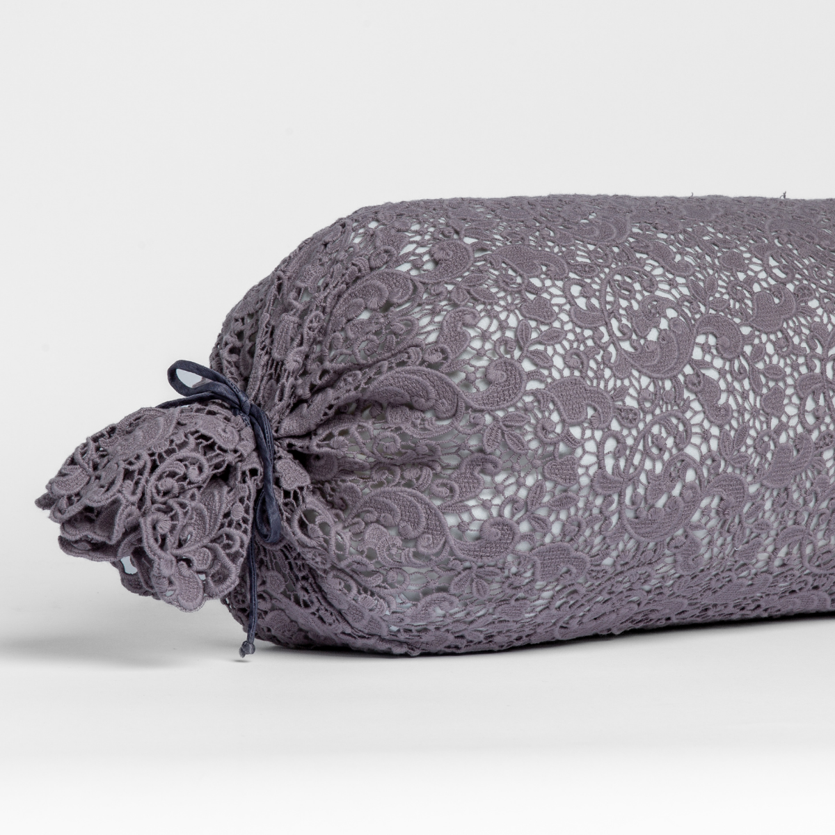 Allora Lace Throw Pillow | French Lavender | one end of a lace boslter cover on a winter white liner against a white background.