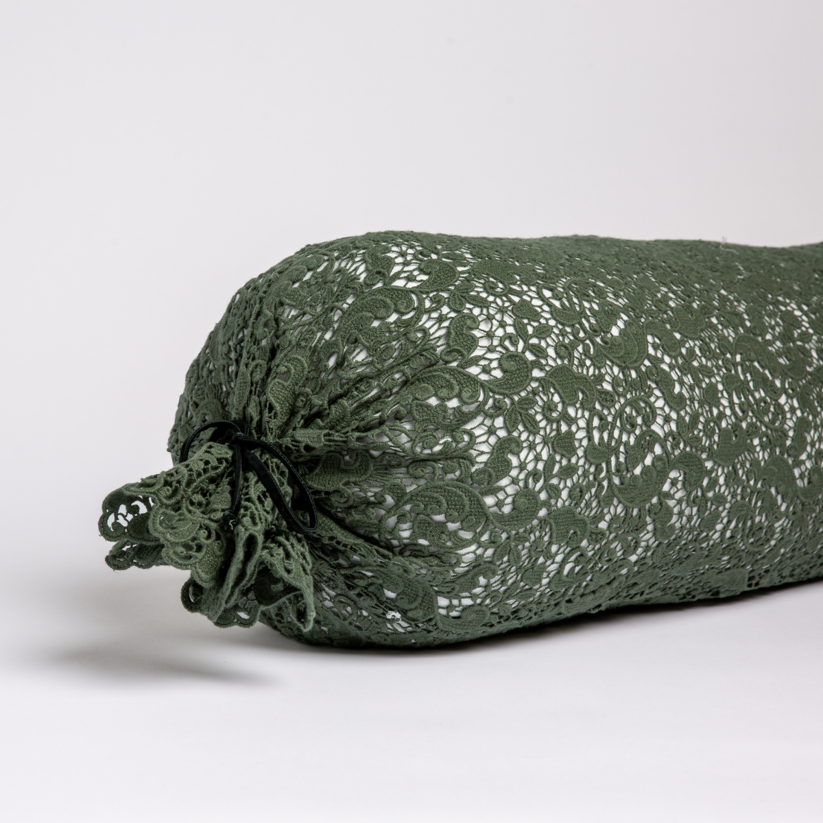 Allora Lace Throw Pillow | Juniper | one end of a lace boslter cover on a winter white liner against a white background.