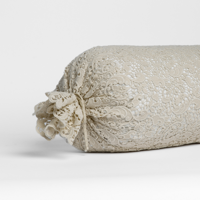 Allora Lace Throw Pillow | Parchment | one end of a lace boslter cover on a winter white liner against a white background.