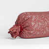 Allora Lace Throw Pillow | Poppy | one end of a lace boslter cover on a winter white liner against a white background.