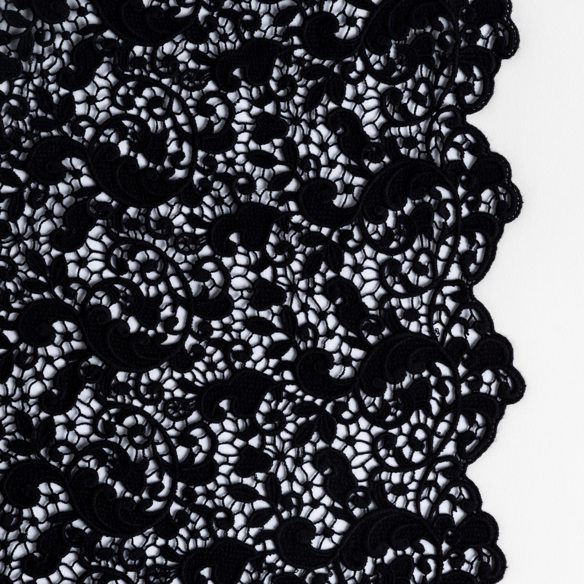 Allora Bed Scarf | Corvino | a close up of cotton all-over lace with a scalloped edge.