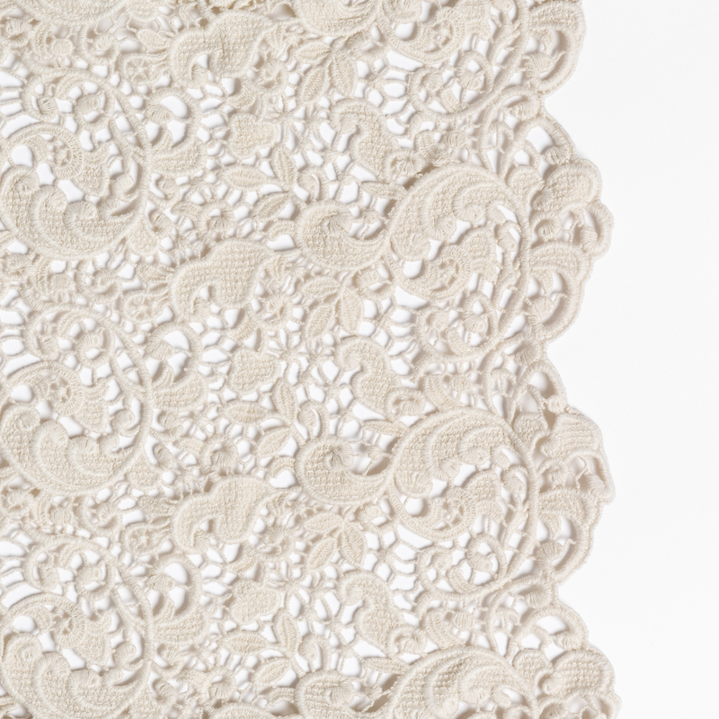 Allora Bed Scarf | Parchment | a close up of cotton all-over lace with a scalloped edge.