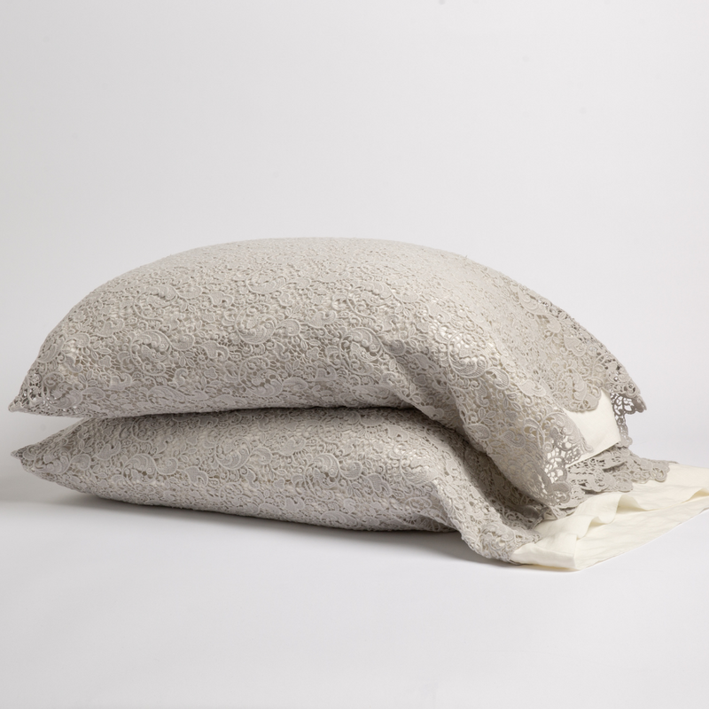 Allora Lace Pillowcase (Single) | Cloud | a pair of stacked cotton lace pillowcase covers on winter white liners against a white background.