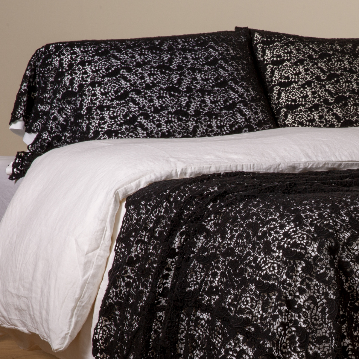 Allora Lace Pillowcase (Single) | Corvino | a pair of cotton lace pillowcase covers on winter white liners shown on a bed dressed in winter white linen with a matching cotton lace bed scarf.