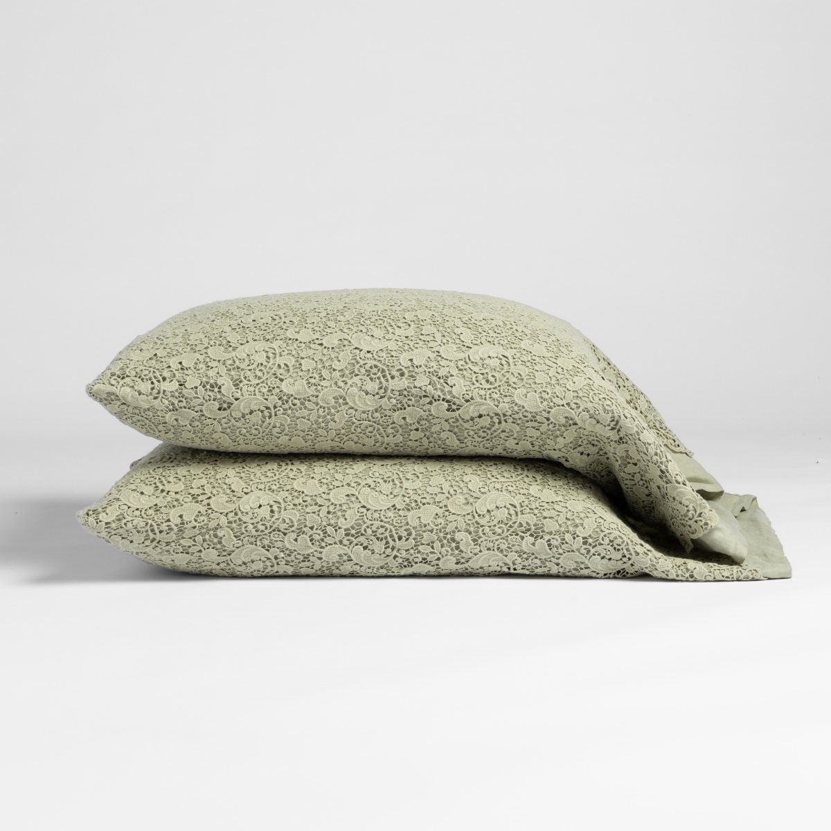 Allora Lace Pillowcase (Single) | Desert Sage | matching pillowcases in desert sage, a serenely elegant green, offering a hushed hue, shown against a plain background.
