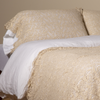Allora Lace Pillowcase (Single) | Parchment | a pair of cotton lace pillowcase covers on winter white liners shown on a bed dressed in winter white linen with a matching cotton lace bed scarf.