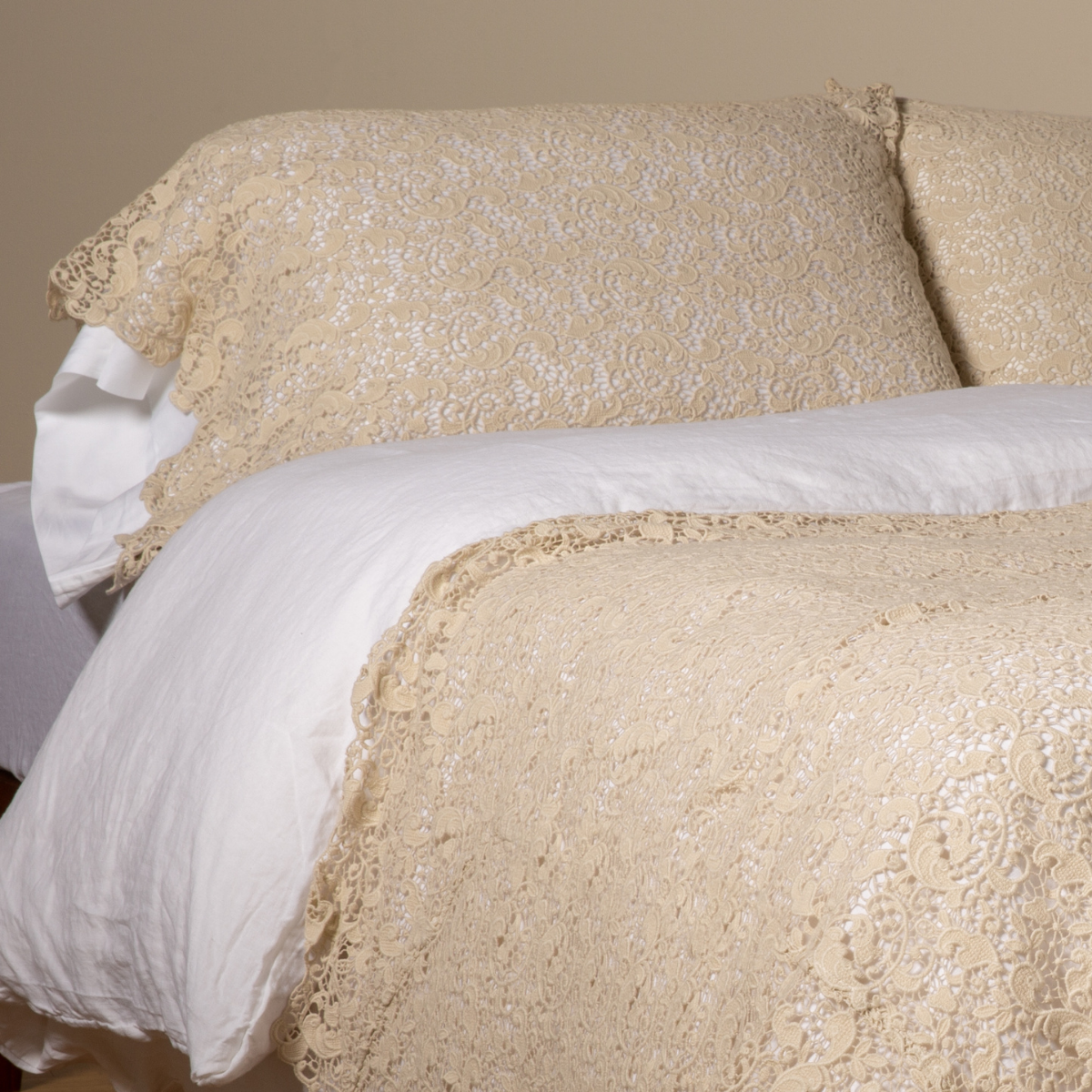 Allora Lace Pillowcase (Single) | Parchment | a pair of cotton lace pillowcase covers on winter white liners shown on a bed dressed in winter white linen with a matching cotton lace bed scarf.